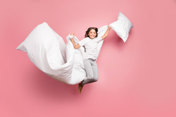 Full length body size view of nice attractive cute playful cheerful cheery wavy-haired pre-teen girl jumping flying with soft cotton pillow blanket isolated over pink pastel color background - obrazy, fototapety, plakaty