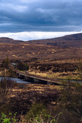 Old rail bridge spanning over a highland loch in Scotland
