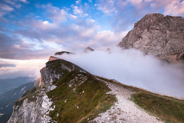 Mangart Mountains Peak above Clouds at Dramatic Sunset in Julian Alps