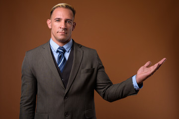 Studio shot of handsome businessman showing copyspace