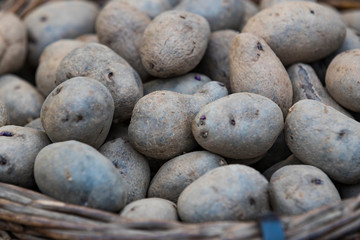 Fototapeta na wymiar Raw potatoes in baskets on the market close up shot