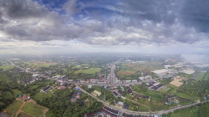 Aerial view panorama above urban, roads and many house with cloudy sky background, Nong Kob District, Ban Pong, Ratchaburi, Thailand.