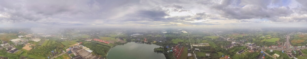 Aerial view panorama 360 degree above reservoir, urban, roads, rice fields and many house with cloudy sky background, Krajub reservoir, Nong Kob, Ban Pong, Ratchaburi, Thailand.