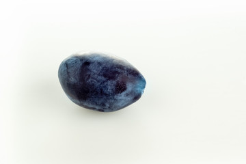 Single ripe juicy plum on white background