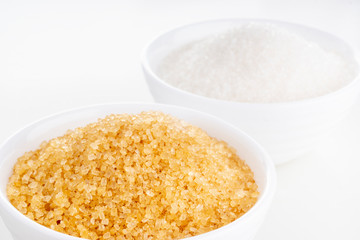 Brown cane and white granulated sugar in white rosettes