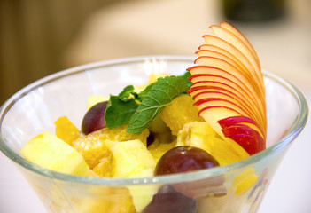 close-up dessert in a glass with tops of fruit and ice cream, a sweet treat