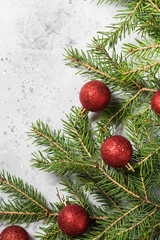 Christmas background with fir branches and red decorations. Top view with copy space