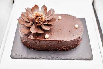 piece of chocolate cake on a stone plate