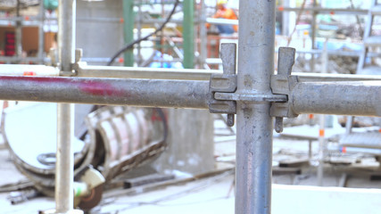 Scaffolding steel pipe fitting CLAMP at construction site, close up photo
