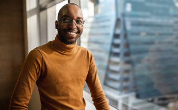 Millennial Black African Creative And Trendy Business Entrepreneur Smiling And Looking Away. With Copyspace