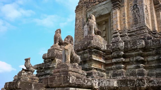 4K, Stone Lion Guardian along the stairway with blue sky and clouds at Pre Rup, The East Baray. General sight and statues of vigilant lions at the archaeological temple in Siam Reap, Cambodia.-Dan