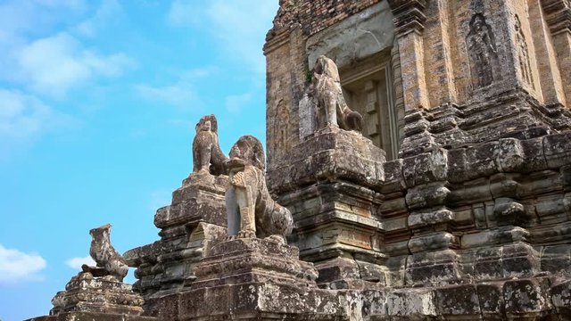 4K, Stone Lion Guardian along the stairway with blue sky and clouds at Pre Rup, The East Baray. General sight and statues of vigilant lions at the archaeological temple in Siam Reap, Cambodia.-Dan