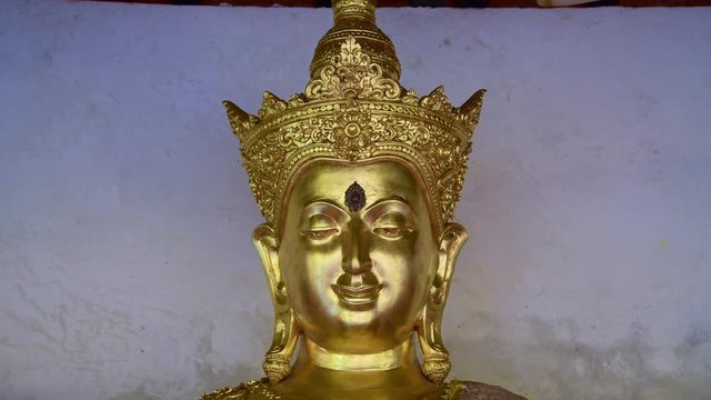 4K video of golden Buddha statue in Phra That Hariphunchai temple, Thailand.
