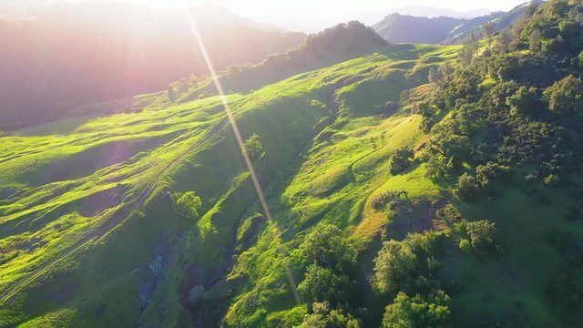 Aerial: Idyllic green landscape against sky during sunset, scenic view of mountains and trees - Napa Valley, California