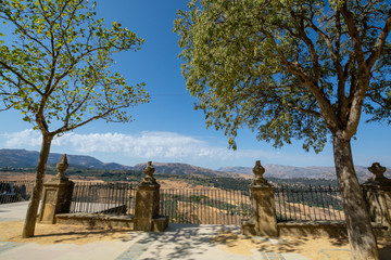 Scenic viewpoint to valley and mountains from Ronda, small ancient white town in Andalusia, Spain