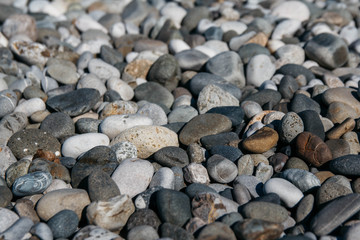 Gravel pattern of colored stones. Abstract nature pebbles background. Stone background. Sea peblles beach. Top view.