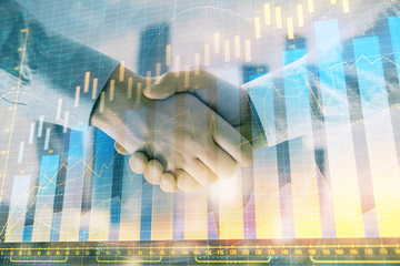 Double exposure of financial graph on cityscape background with two businessman handshake. Concept of stock market deal