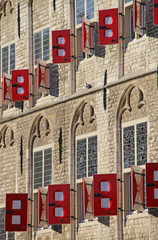 Obraz premium Gouda, Netherlands - October 28, 2019: Facade with windows and red shutters of Town Hall on Market Square in Gouda, Netherlands.