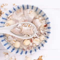 Tasty Four Tonics Herb Flavor Soup,Taiwanese traditional food with herbs,pork intestines on white wooden table,close up,flat lay,top view
