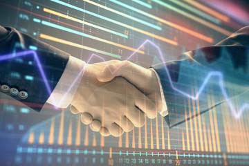 Multi exposure of forex graph on abstract background with two businessmen handshake. Concept of success on stock market