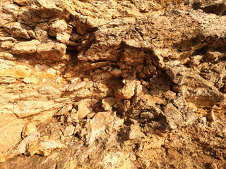 Surface of the rock with a yellow stone texture
