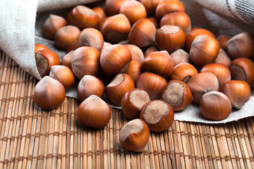 close up of hazelnuts on wooden table .