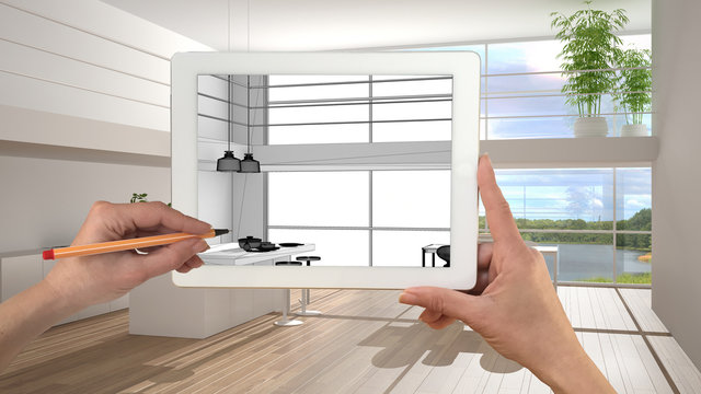 Hands holding and drawing on tablet showing modern white kitchen with wooden details CAD sketch. Real finished interior in the background, architecture design presentation