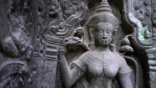 4K, God statue at Ta Prohm temple. Figure of one deities in Hinduism. Ancient monument ruins in Angkor Thom Cambodia. A popular tourist destination near Siem Reap in Asia.-Dan
