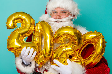 Santa holding 2020 balloons