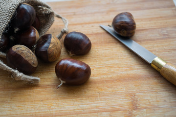chestnuts close-up inside a small sack and a knife