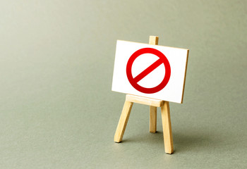 Stand with a canvas and a red prohibition sign NO. Inability to sell products, ban on the import....