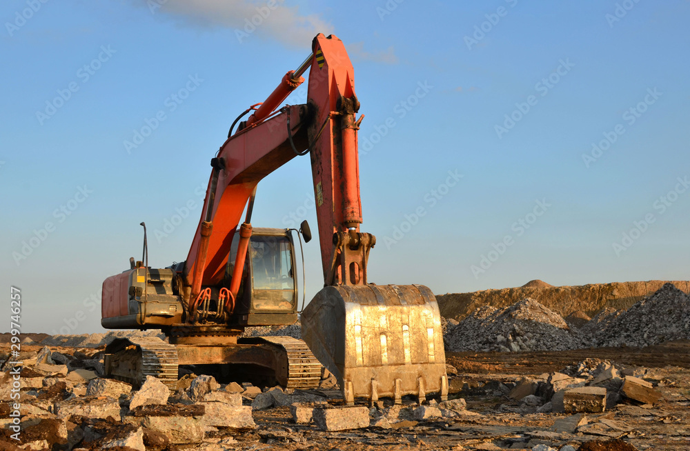 Canvas Prints large tracked excavator works in a gravel pit. salvaging and recycling building and construction mat