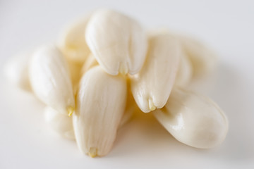 row, line of peeled young almonds on a white background, isolate, nut antioxidant