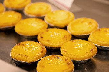 Dessert egg tart or portugal egg tart sweet custard cream on paper box set. Selective focus.