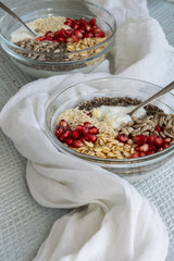 Healthy breakfast mood, muesli with raw pomegranate, sunflower and sesame seeds.