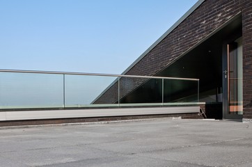 Fototapeta na wymiar Modern Dutch architecture. Glass panels. Banister. Balcony. Handrail.