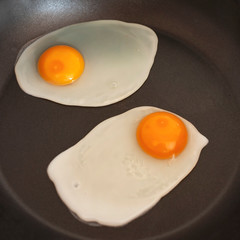 fried egg closeup on dark background