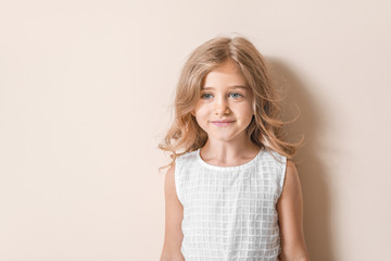 Cute little girl on light background