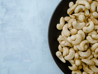 Cashew on light blue background, Top view.