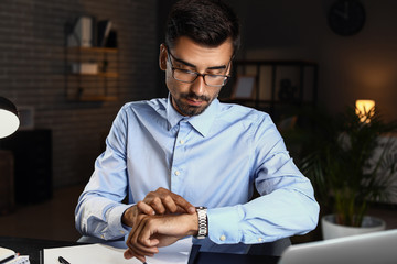 Young businessman trying to meet deadline in office late in evening
