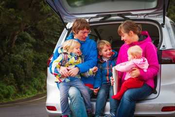 family with kids travel by car on road in nature