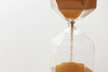Crystal hourglass on light background, closeup