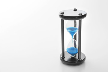 Crystal hourglass on light background