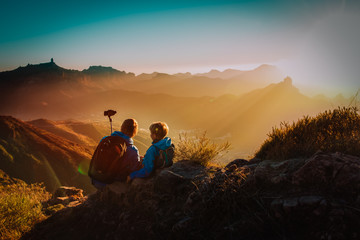 father with son making selfie in mountains, family travel