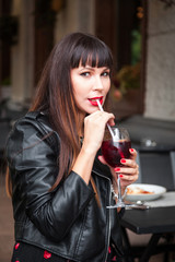 Woman drinking wine, sangria in outdoor cafe