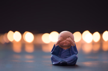 Three Monkeys concept  ( I don't know, I haven't seen or heard ) Monk baby covers his eyes with his...