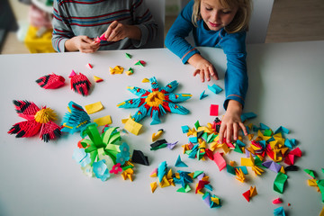 kids making origami crafts with paper, learning activities
