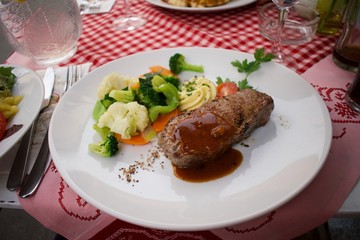 grilled steak with sauce and vegetables