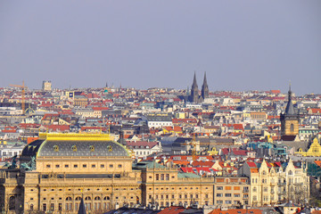 Fototapeta na wymiar Panoramic view of Old Town in Prague in a beautiful summer day. Top view to colorful roofs skyline of capital city Prague, Czech republic. 