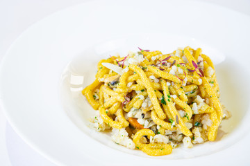 Homemade passatelli, a traditional Italian recipe. Pasta with fish sauce. Italian cuisine. White background - image